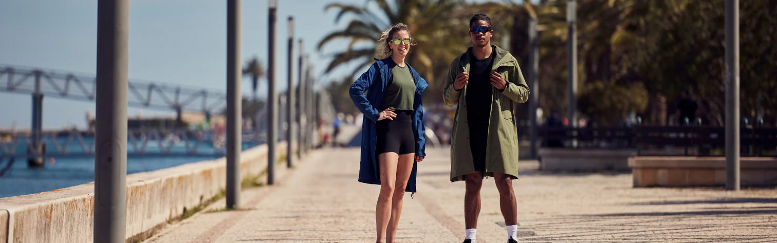 A man and woman wearing the pursuit changing robe on the street