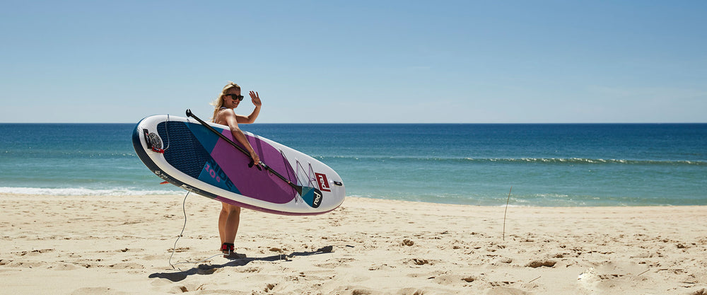 woman holding ride paddleboard