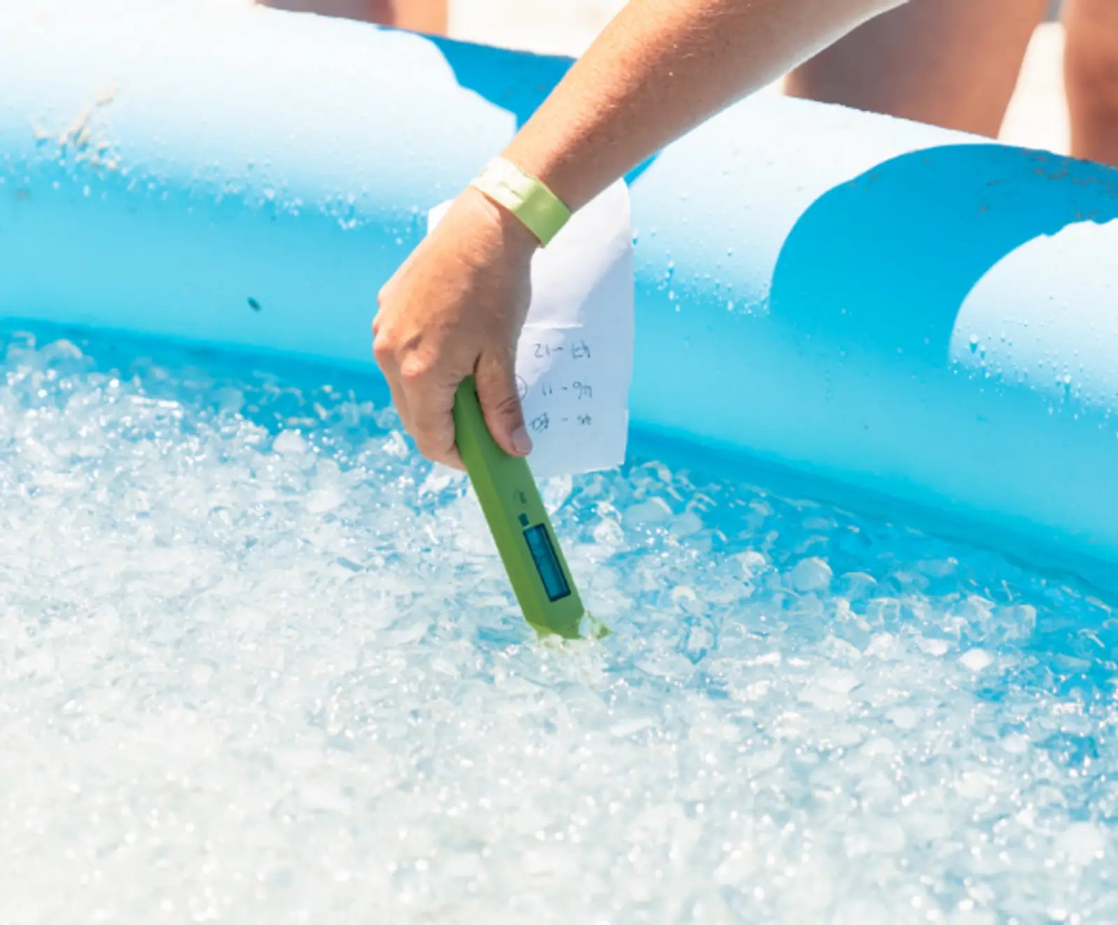 Someone testing the temperature of an icebath