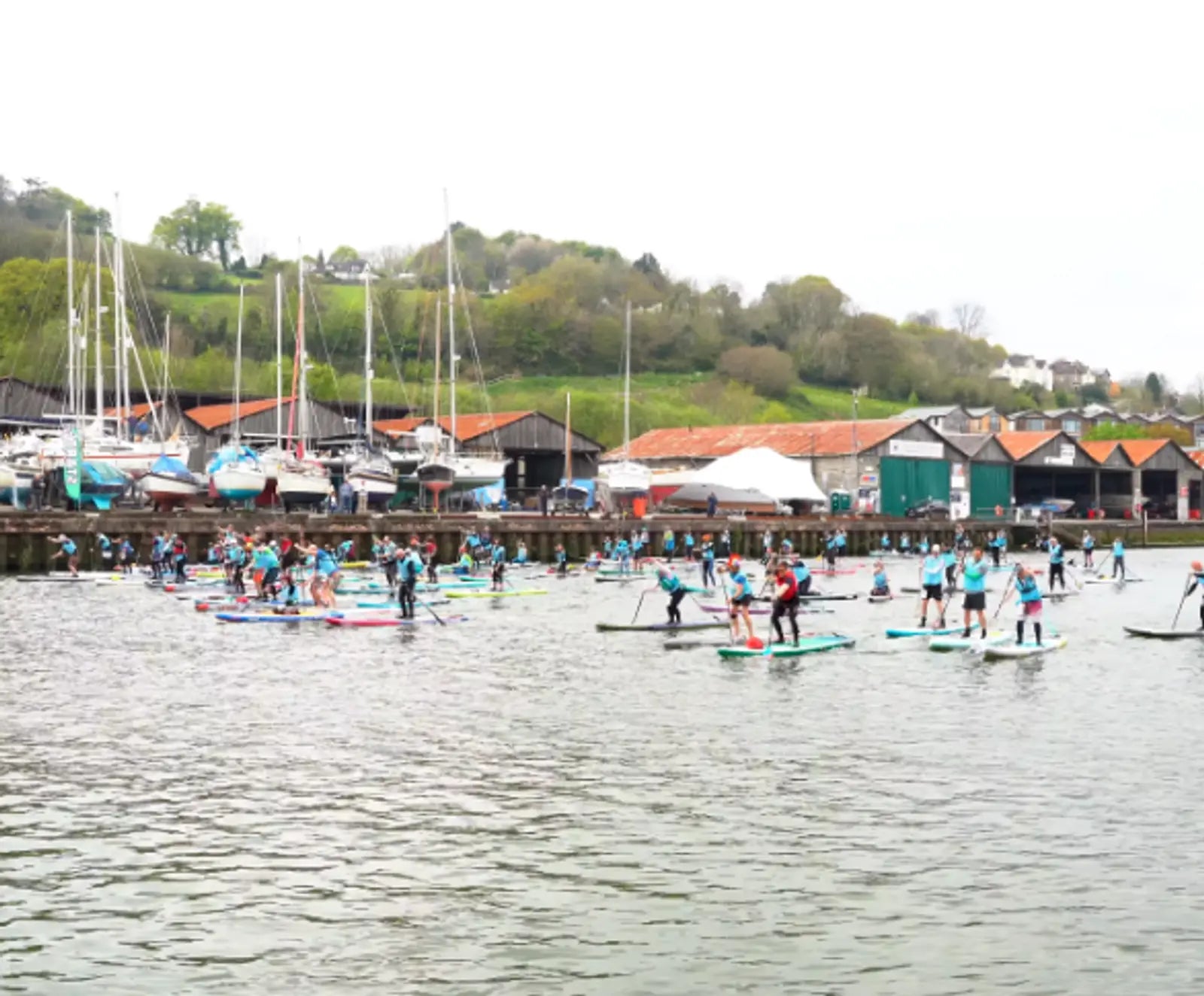 A group of people participating in a paddleboarding race