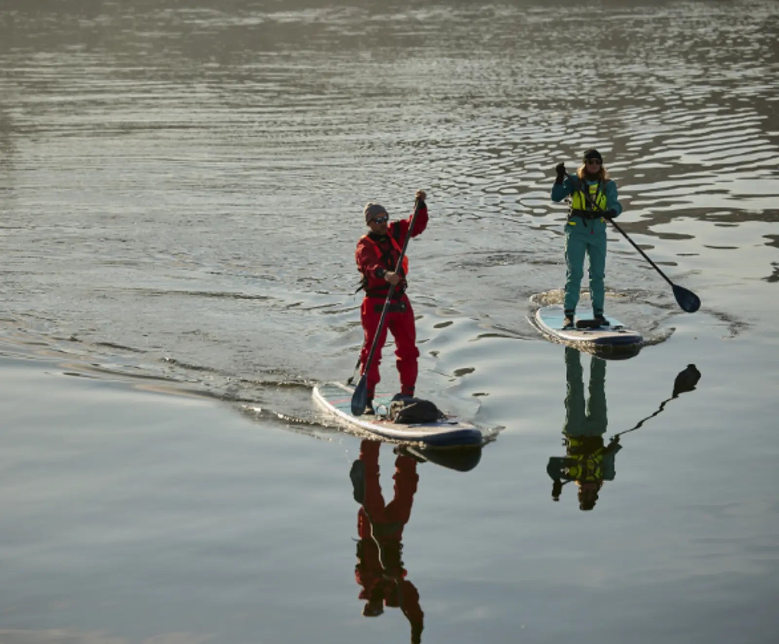 2 people paddleboarding in the cold