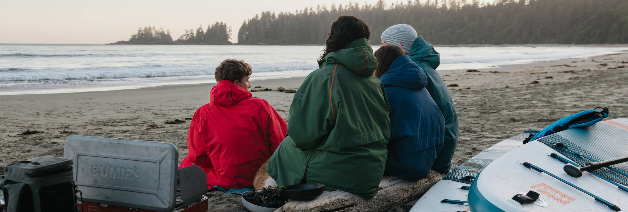 family wearing changing robes on beach