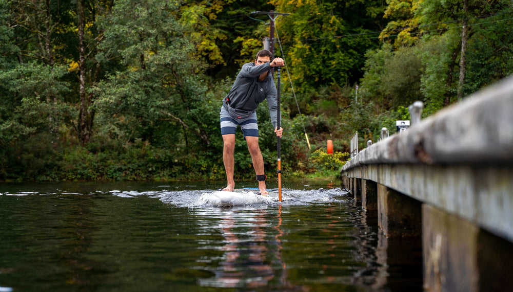 man using racing sup