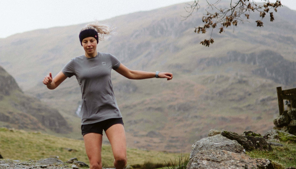 woman running wearing grey performance t shirt