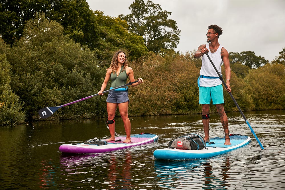 Man and woman paddling Red Original 10'6 paddle board