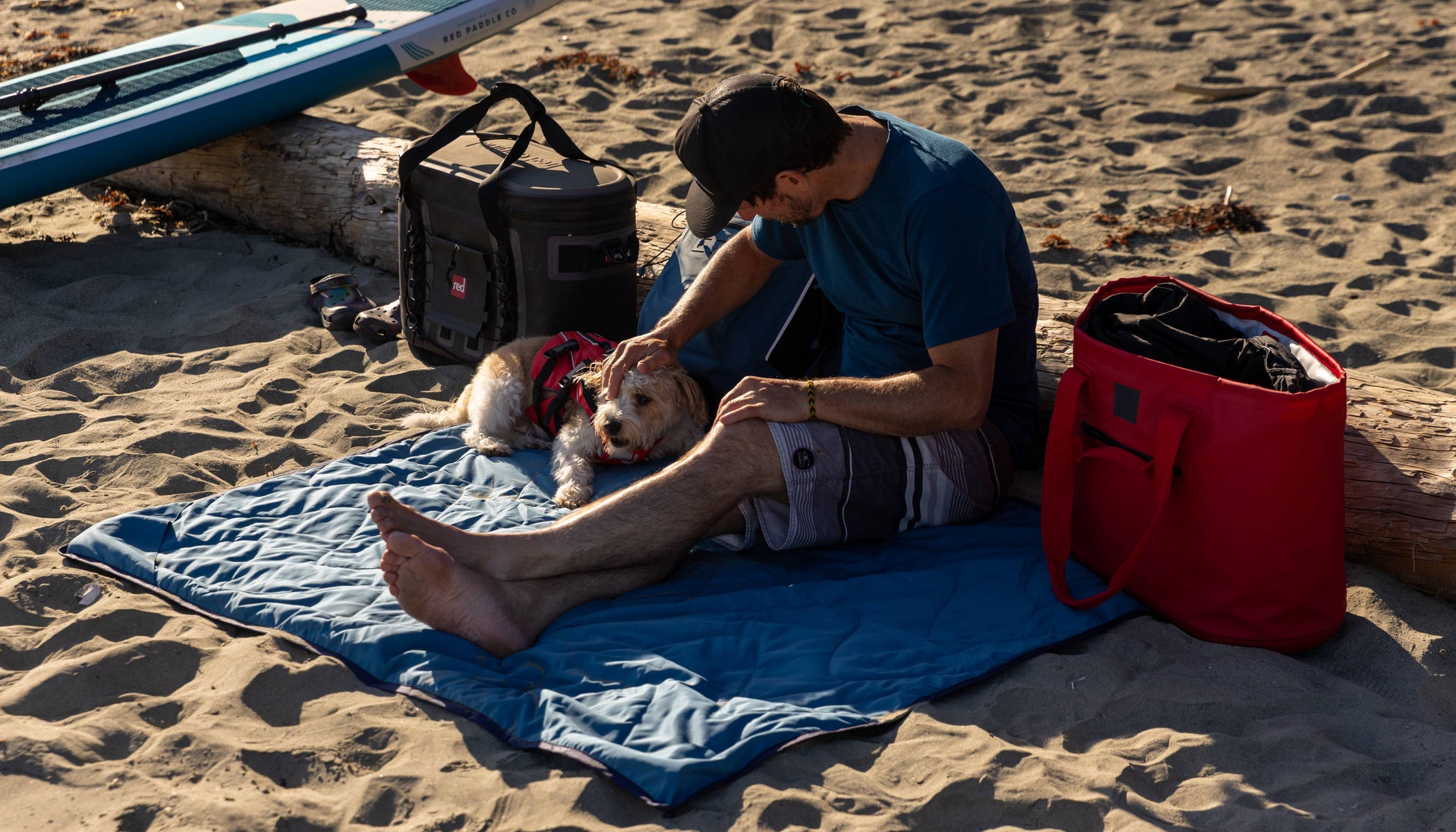 man sat on red adventure waterproof blanket
