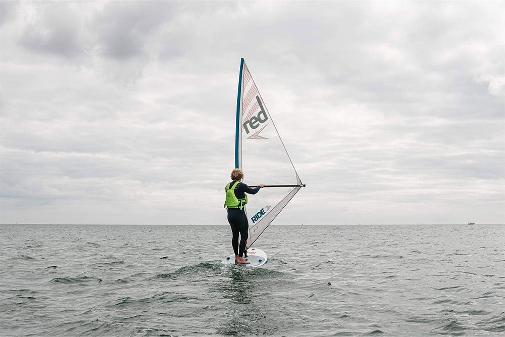 Man paddle boarding Red Original Windsurf MSL in the sea 