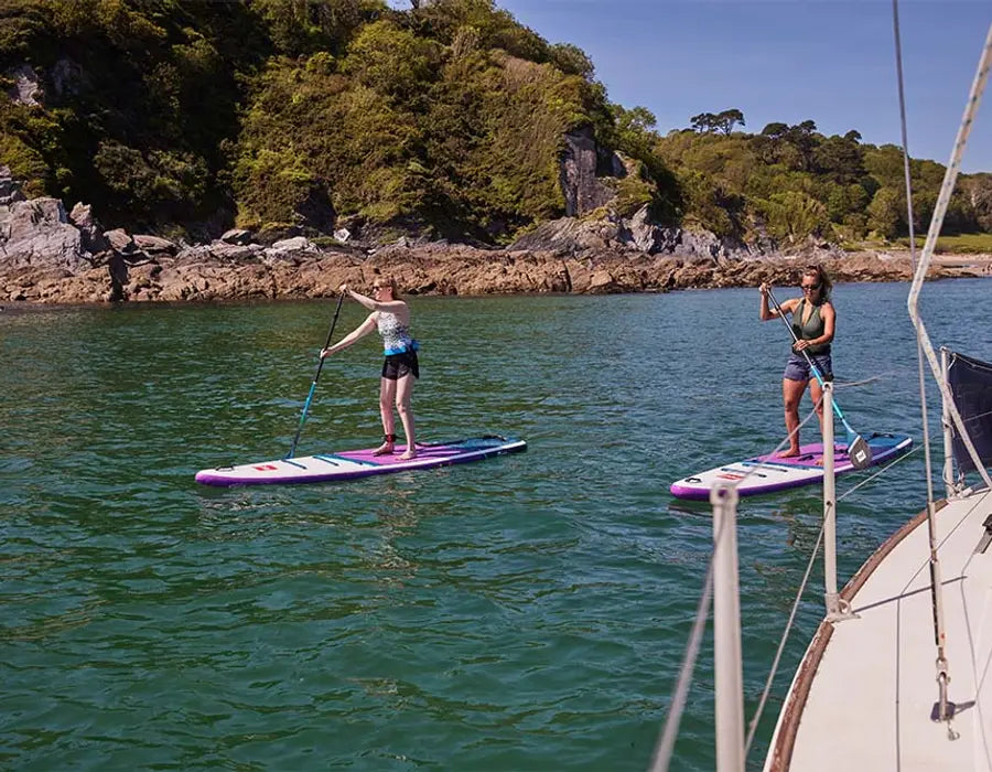 2 women paddleboarding in the ocean