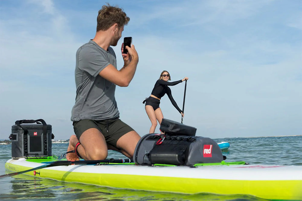 man and woman on paddleboards with dry deck bag