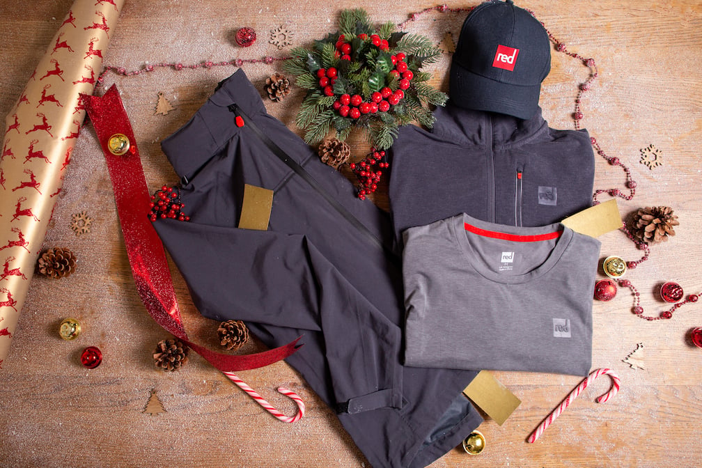 An array of Red Original activewear surrounded in Christmas accessories  