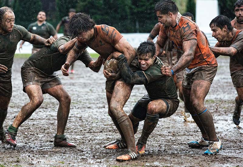 rugby players in the mud