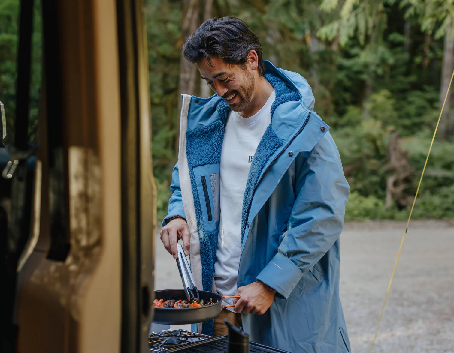 A man cooking on the BBQ wearing the alter evo robe