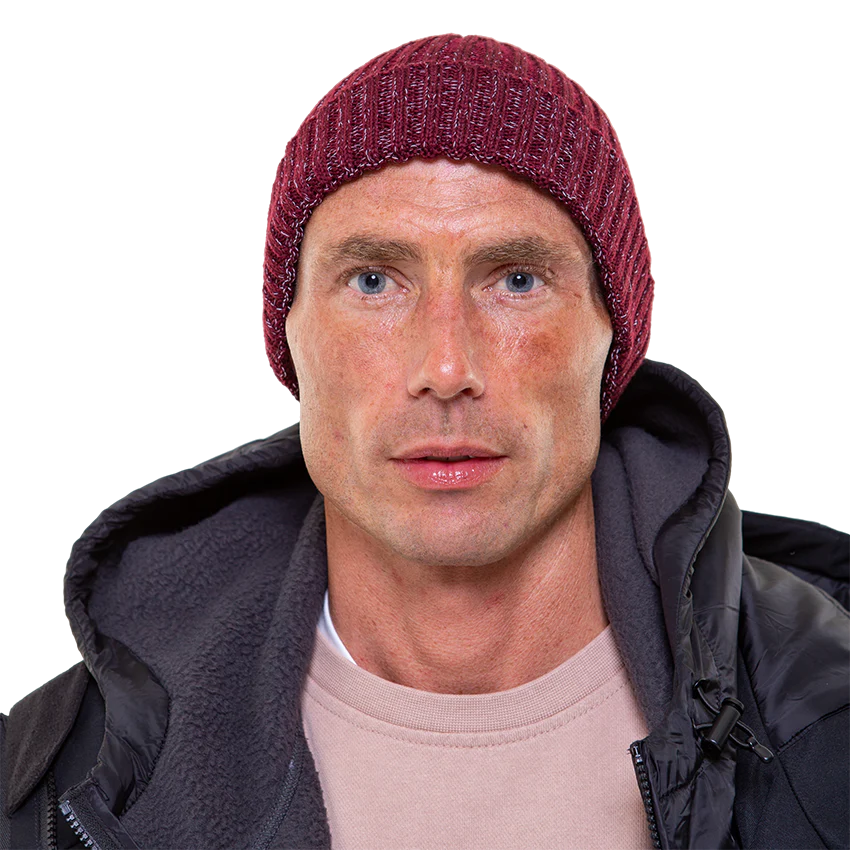 A man wearing the burgundy merino beanie looking into the camera