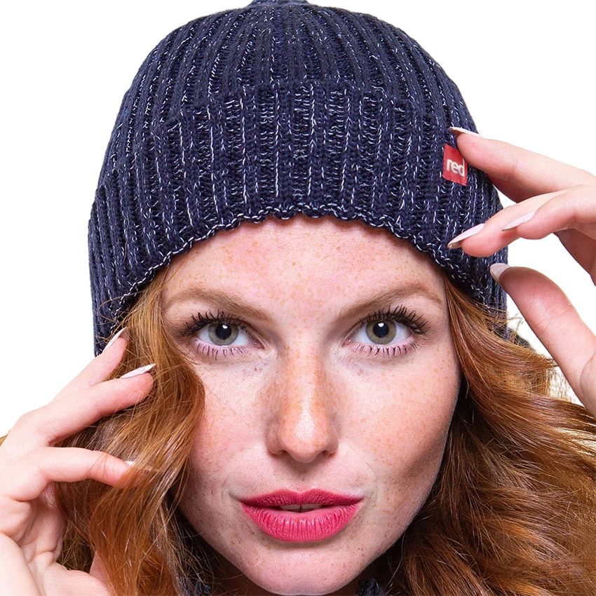 A woman wearing the navy merino beanie looking straight at the camera